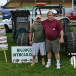 John Owen Patterson and John Hunt stand in front of a green buggy at the Big Dogs Offroad Booth during the PA All Breeds Jeep Show in York, PA.