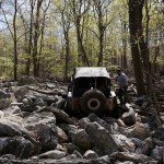 A 4W2H volunteer spots for a Jeep in the midst of a large rock garden
