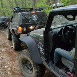 Jeeps on a dirt trail in the woods