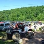 Jeeps lined up in a field for the Spring Fling drivers meeting. Tank Killer sitting in front